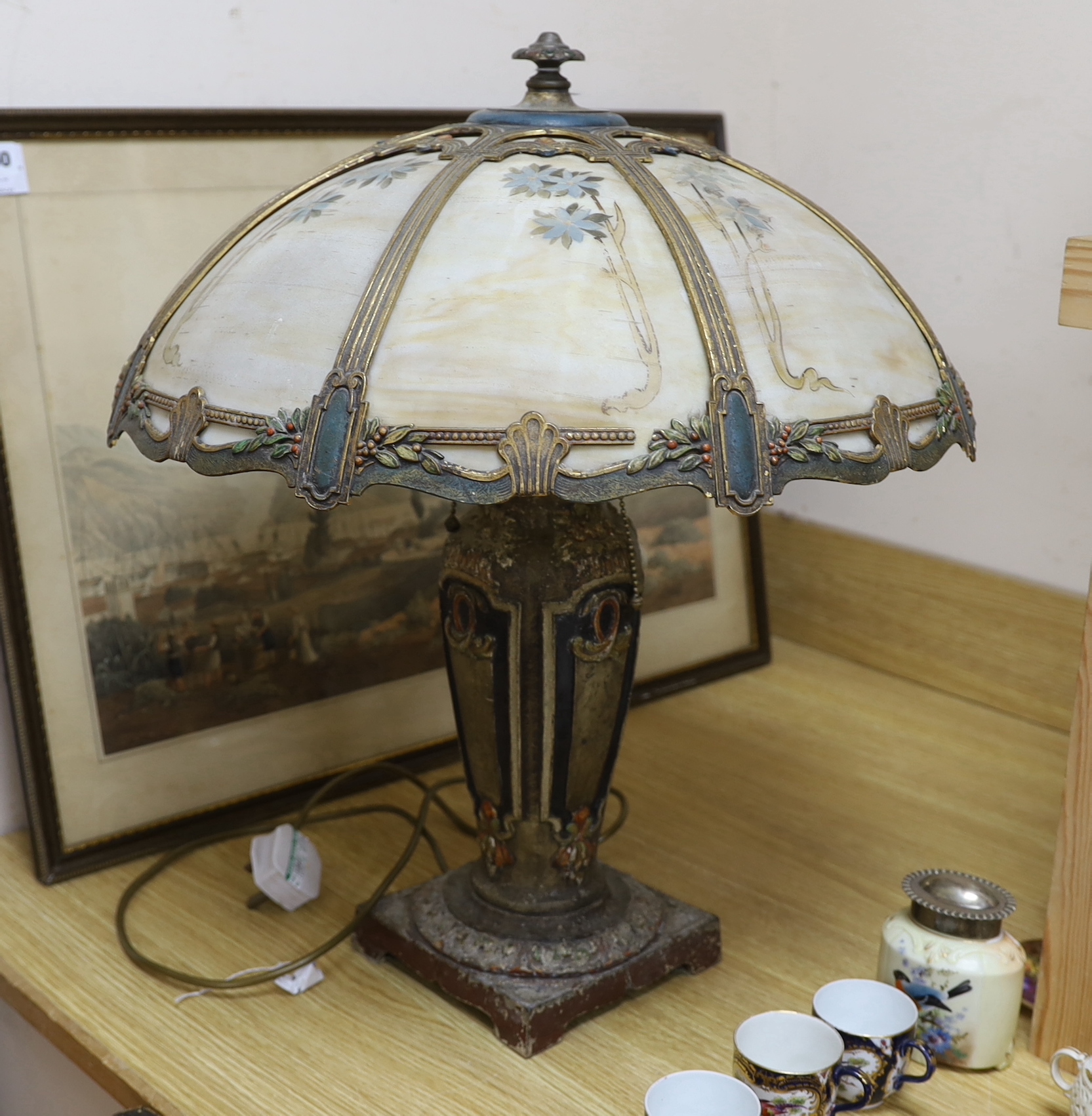 An early 20th century American ‘Miller & Co’ painted spelter and opaque glass table lamp, 55cms high